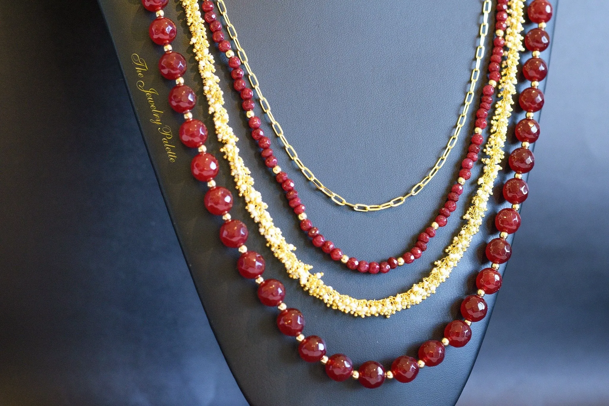 Irene luxurious maroon and gold four tier necklace